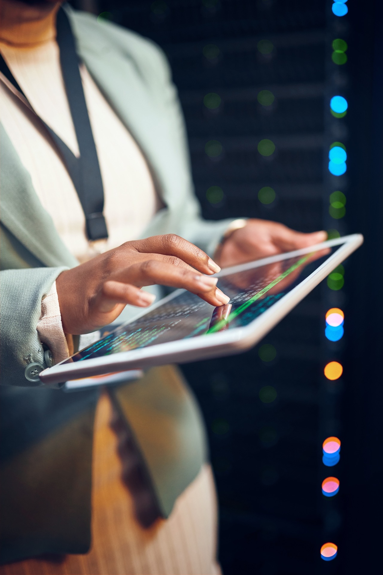 Professional using tablet technology in a dark office
